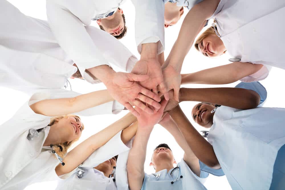 medical team stacking hands in a huddle