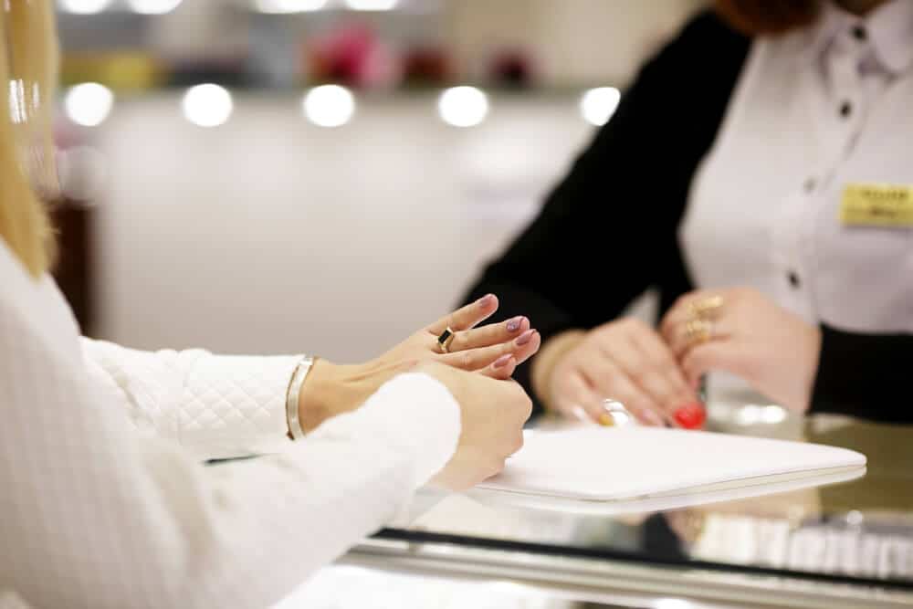 woman trying on resized ring in jewelry store