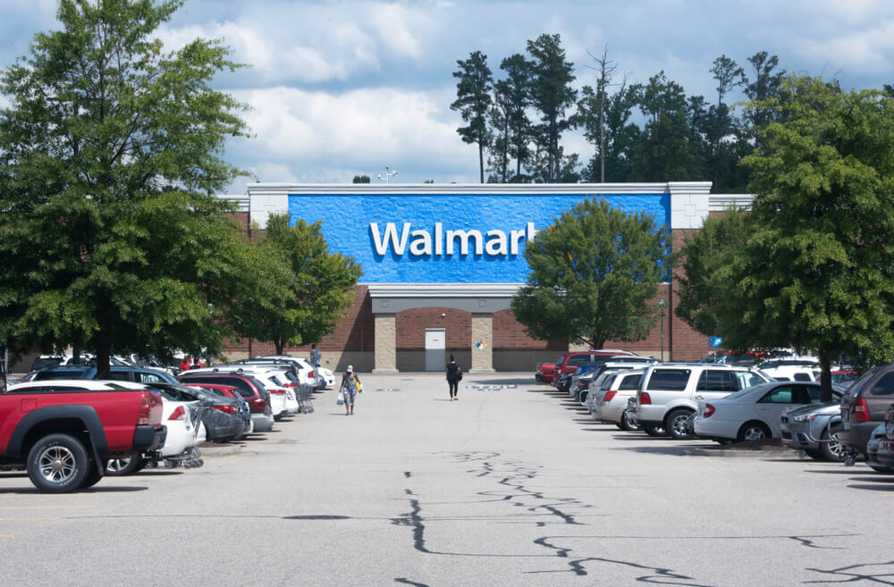 An image of a Walmart store taken from the perspective of someone walking towards it.
