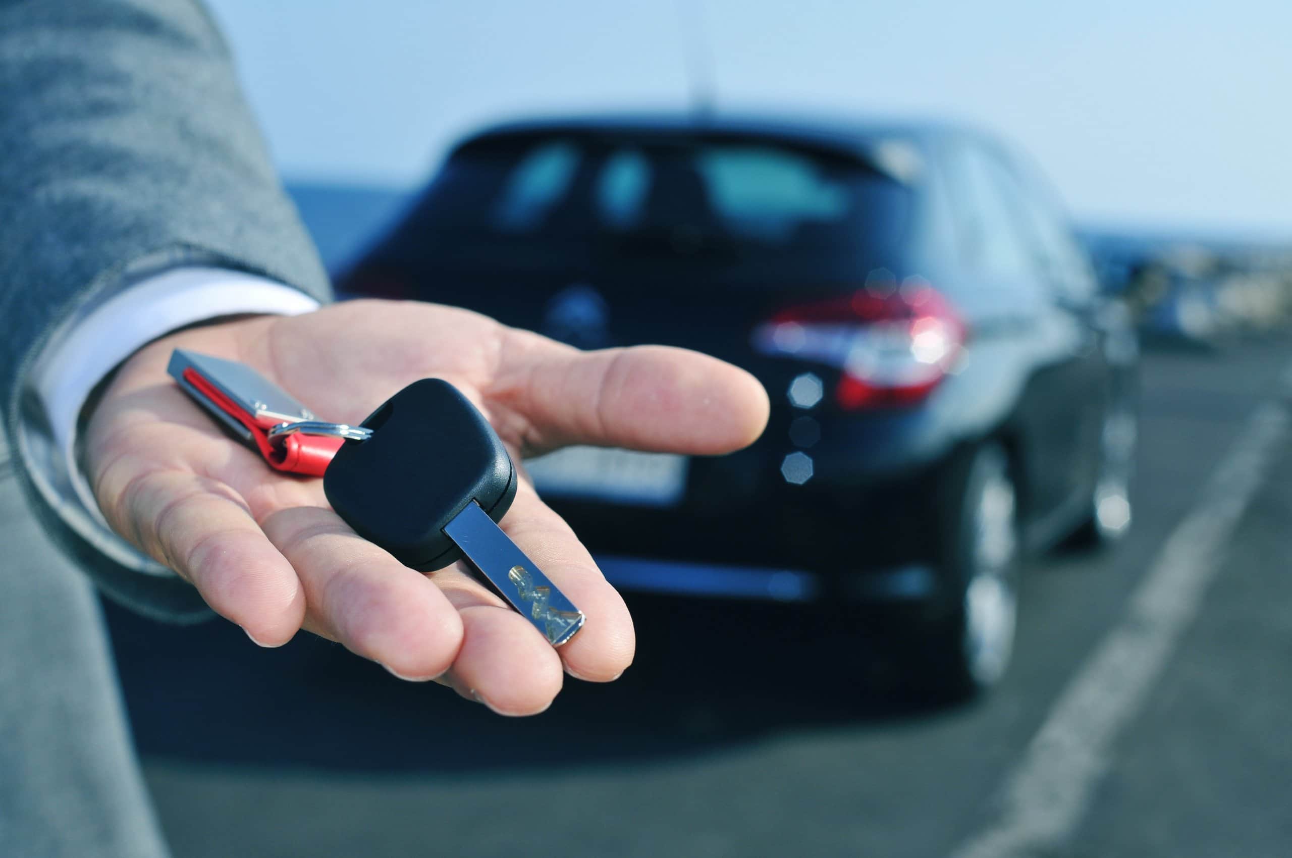 man handing over keys to rental car