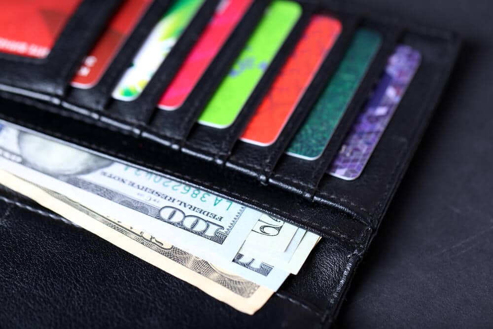 A wallet containing gift cards and cash.
