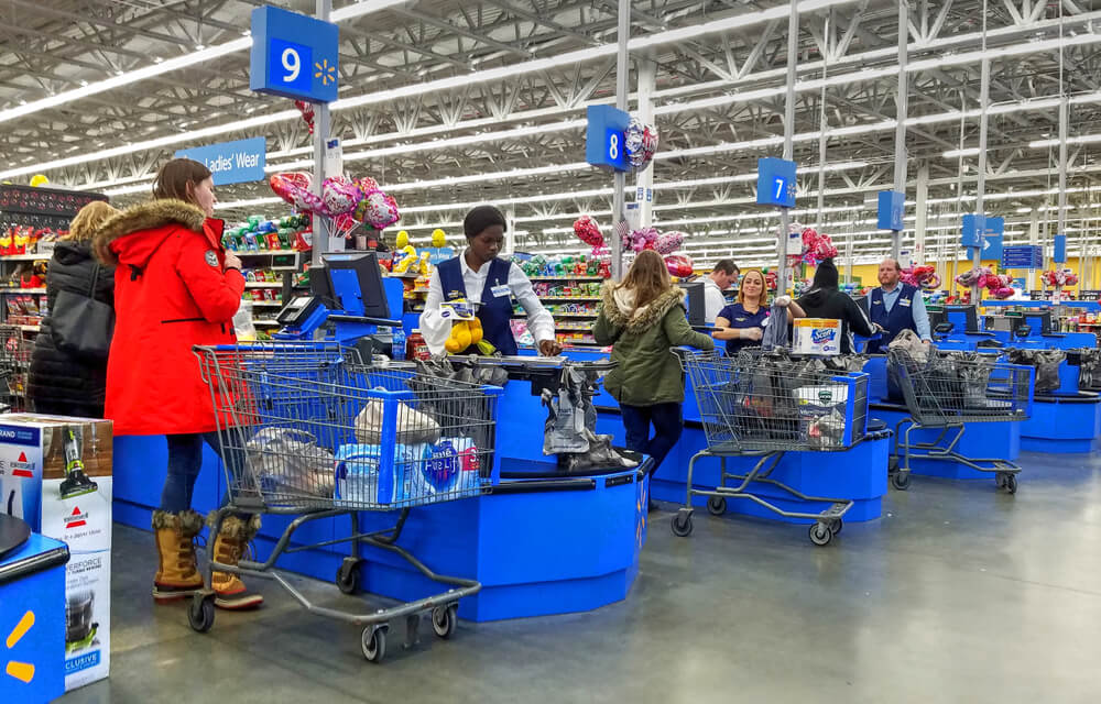 Walmart employees working at checkout