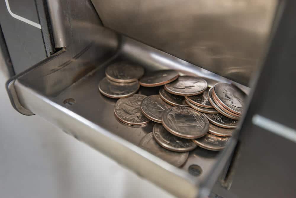 Quarters coming out of a change machine.
